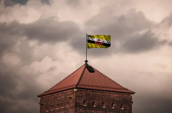 Beautiful flailing flag on the roof of the old fortress — Stock Photo, Image