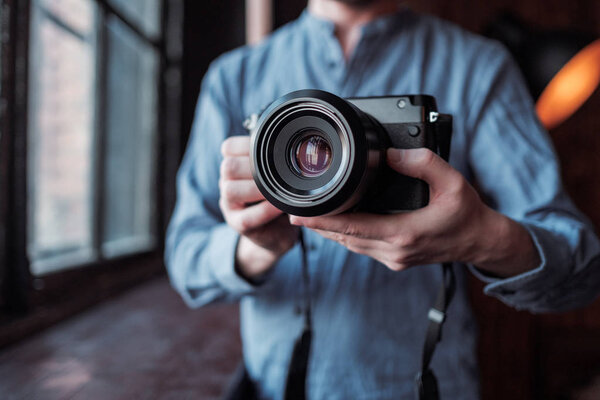 Camera in hand. Close-up of hand holding camera