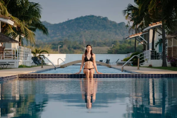 Güzel yüzme havuzunun yakınında rahatlatıcı kadın.