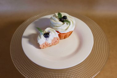 bir tabakta yaban mersini ve yaban mersini ile cupcakes