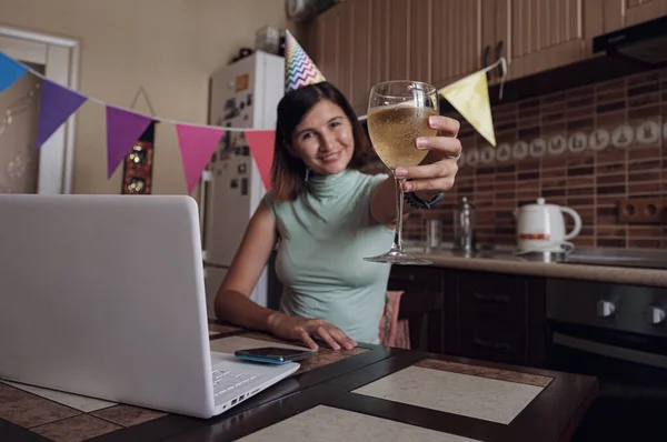 Asian woman virtual happy hour meeting birthday party with cake online, together with her friend in video conference with laptop for online meeting in video call , for social distancing