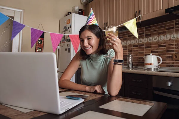 Asian woman virtual happy hour meeting birthday party with cake online, together with her friend in video conference with laptop for online meeting in video call , for social distancing