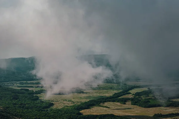 the view through the clouds of the valley before the rain. bird's-eye view, spring.