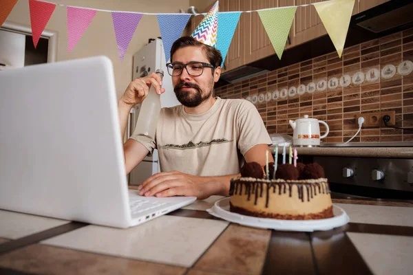 Man celebrating birthday online in quarantine time. Video conference party online meeting with friends and family. Birthday party in facetime call. Long Distance Celebration.