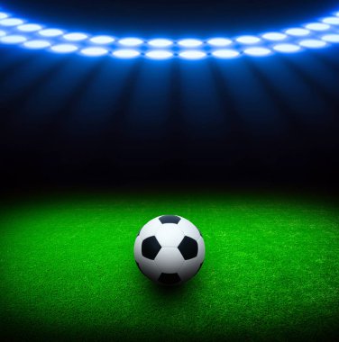 Futbol topu yeşil stadyumda, arena gece aydınlandı parlak spot ışıkları