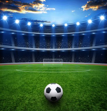 Futbol topu yeşil stadyumda, arena gece aydınlandı parlak spot ışıkları