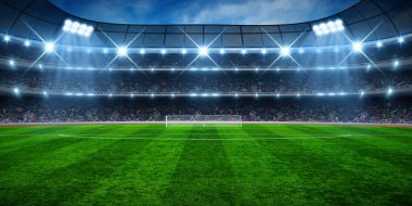 Yeşil futbol stadyumu, aydınlatılmış saha, gece arenası.