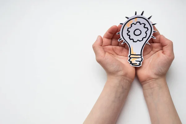 Drawn light bulb in hands on a white background — Stock Photo, Image