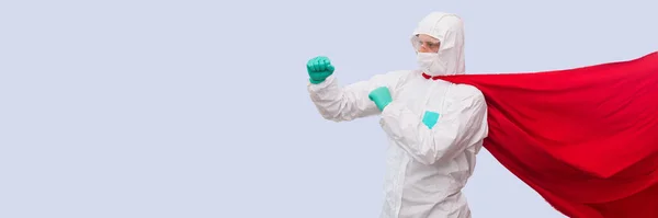 A doctor in a costume of a super hero stands on defense against a viral pandemic