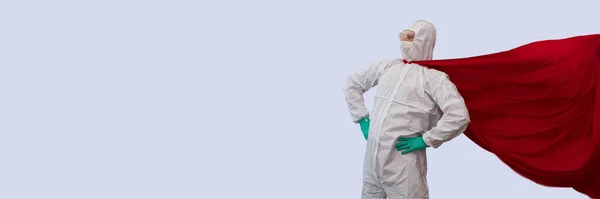 A doctor in a costume of a super hero stands on defense against a viral pandemic — Stock Photo, Image