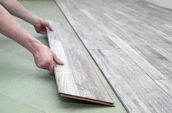 Close up of male hands installing new laminated flooring in room — Stock Image Close Male Hands Installing New Laminated Flooring Room Stock Image