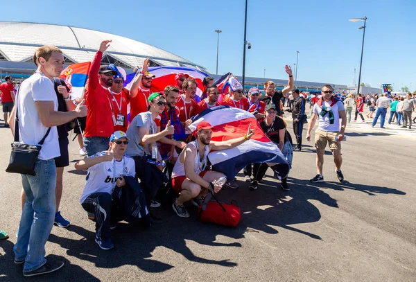 Samara, Rusya - 17 Haziran 2018: Neşeli ve dekore edilmiş futbol taraftarları 2018 Dünya Kupası sırasında Samara Arena Stadı yanındaki Kosta Rika bayraklı