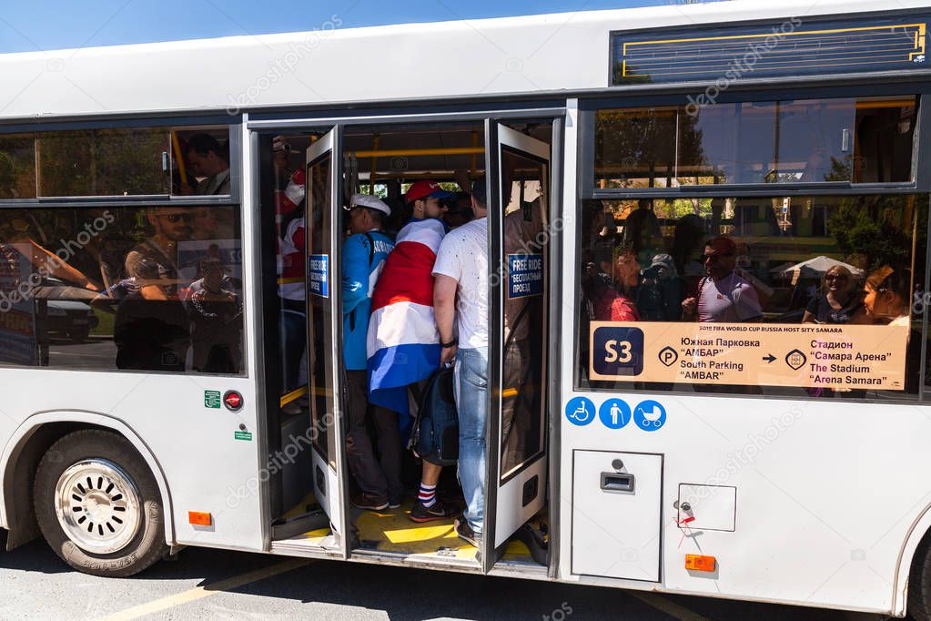 Samara, Russia - June 17, 2018: Shuttle bus with football fans on city street during the 2018 FIFA World Cup