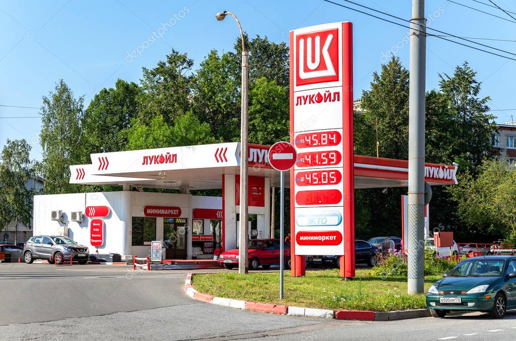 Saint Petersburg, Russia - August 10, 2018: Lukoil gas station with fueling cars. Lukoil is one of the largest russian oil companies