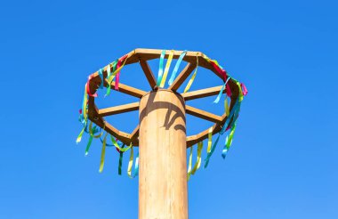 Rusya shrovetide kutlama. Mavi gökyüzü arka plan üzerinde renkli kurdeleler ile ahşap tekerlek