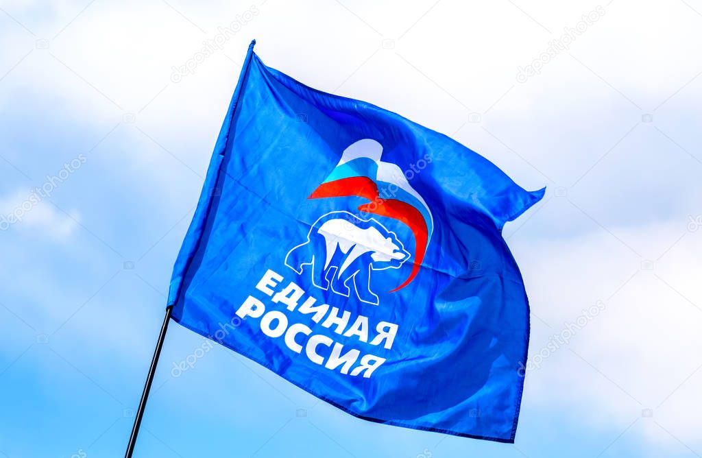 Samara, Russia - May 1, 2019: Flag of the party United Russia against the blue sky