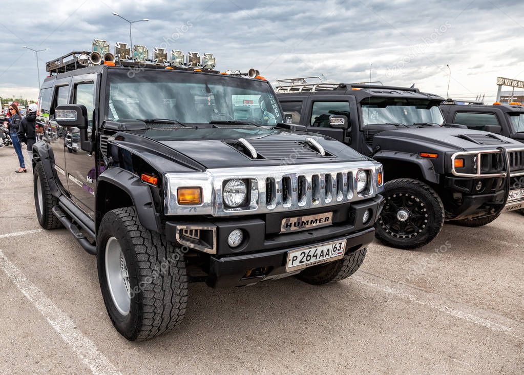 Samara, Russia - May 18, 2019: Black luxury cars Hummer parking at the city street in Samara, Russia