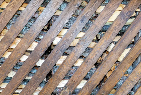 Chopped and stacked up dry firewood with diagonal boards — Stock Photo, Image