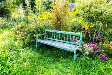 Çiçek bahçesindeki eski ahşap bank