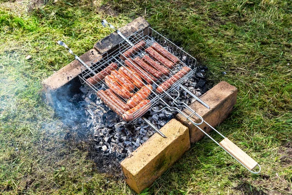 Delicious sausages from meat on a metal grid