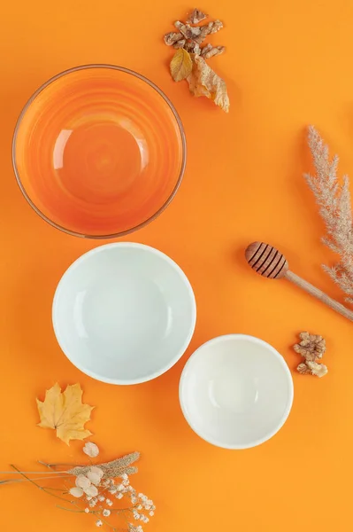 Three empty bowls of different sizes on a bright orange backgrou Royalty Free Stock Images