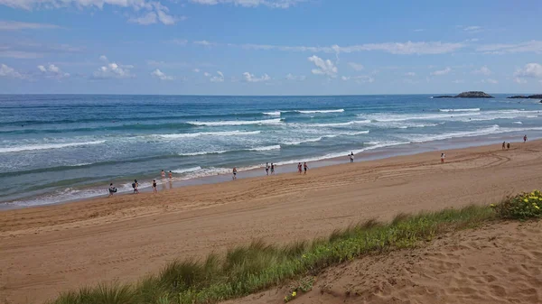 ZARAUTZ,スペイン- 2020年7月11日:美しい夏の日にスペインのバスク地方を歩く人々とサラウツビーチへの空中ビュー — ストック写真