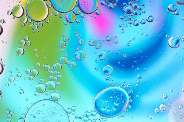 Defocused multicolored abstract background picture made with oil, water and soap with mooving boubbles — Stock Photo, Image