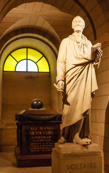 Voltaire's tomb and statue in the crypt of the Pantheon in Paris