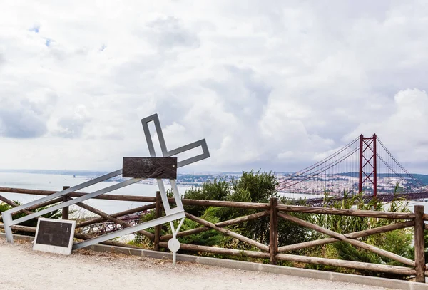 Installation med en fallen metall korsning nära Kristus kungen staty i Lissabon, Portugal — Stockfoto