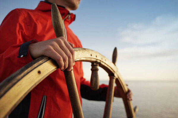Captain Holding Hands on ship rudder 