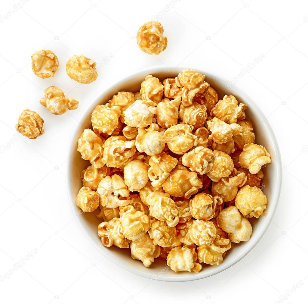 bowl of caramel popcorn isolated on white background, top view