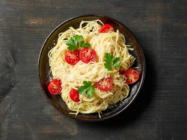 Talíř Těstoviny Špagety Sýrem Rajčaty Tmavý Dřevěný Stůl Pohled Shora — Stock fotografie