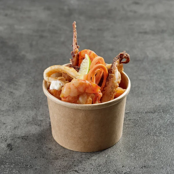 Fried sea food snacks in paper box — Stock Photo, Image