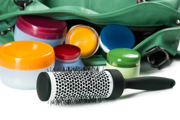 Women bag comb and jars of creams on a white background — Stock Photo, Image