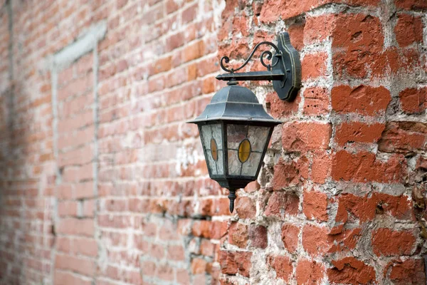 Vintage lantern on a red brick wall close up — Stock Photo, Image