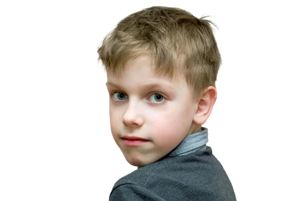 The boy looks half-turned right into the camera on a white backg — Stock Photo, Image