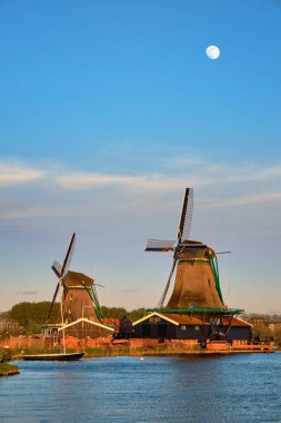 Windmills at Zaanse Schans in Holland in twilight on sunset. Zaa clipart