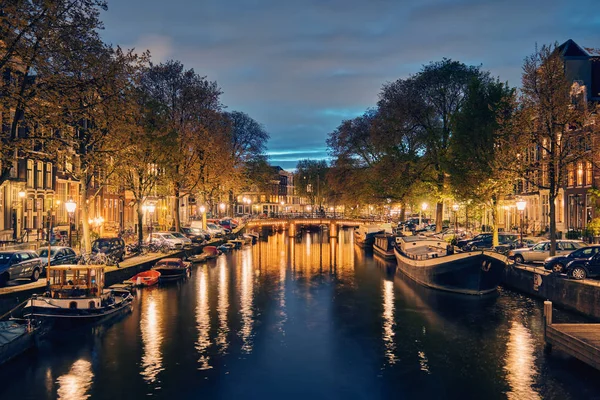 Amterdams kanal, bro och medeltida hus på kvällen — Stockfoto