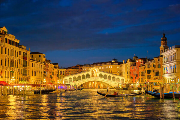 Rialto bridge Ponte di Rialto over Grand Canal at night in Venice, Italy