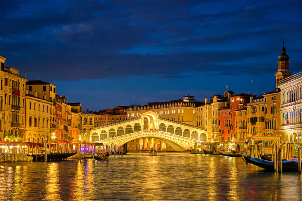 Rialto bridge Ponte di Rialto over Grand Canal at night in Venice, Italy