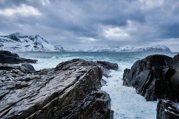 Norské mořské vlny na skalnatém pobřeží Lofotenských ostrovů, Norsko — Stock fotografie