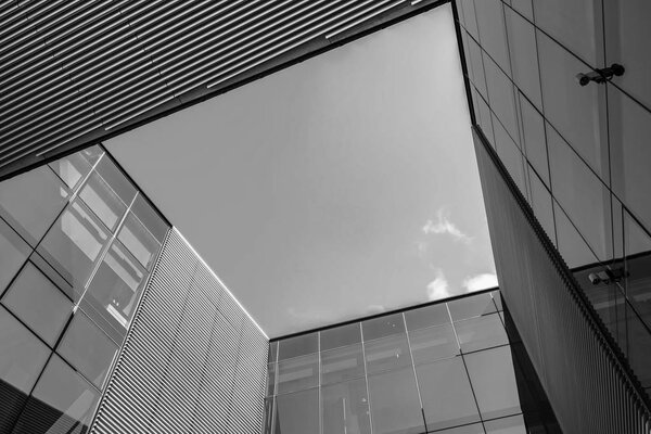 Abstract architecture background with blue sky and modern office building with reflection in the window glass