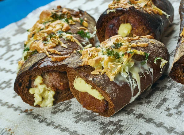 Bread stuffed with meatballs with garlic sauce
