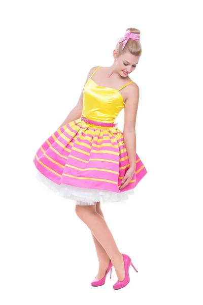 美丽的年轻女子摆在五颜六色的郁郁葱葱的礼服 在白色上隔离 — 图库照片