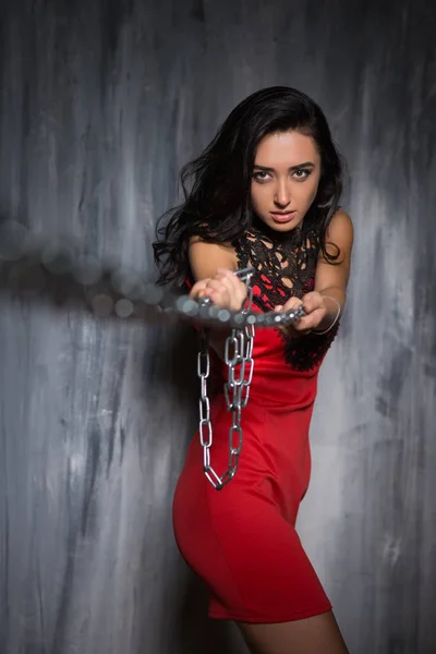 Portrait Young Woman Red Short Dress Pulling Chains Front Grey — Stock Photo, Image