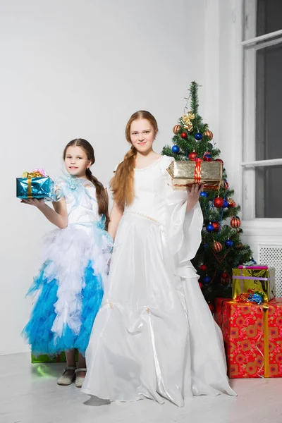 Hermanas Vestidos Festivos Posando Cerca Del Árbol Navidad Estudio —  Fotos de Stock
