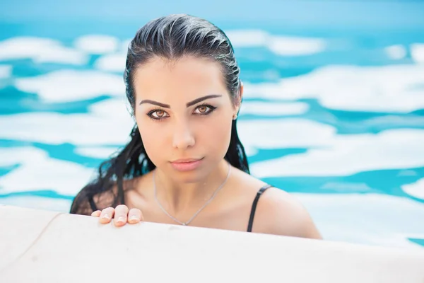 年轻性感的黑发女子在游泳池休息 — 图库照片