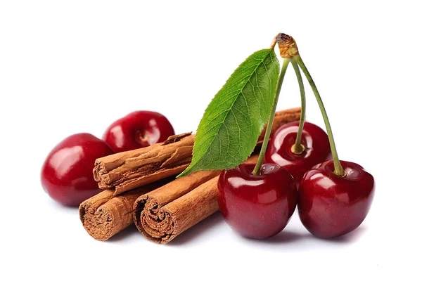 Sweet cherry and cinnamon sticks. — Stock Photo, Image