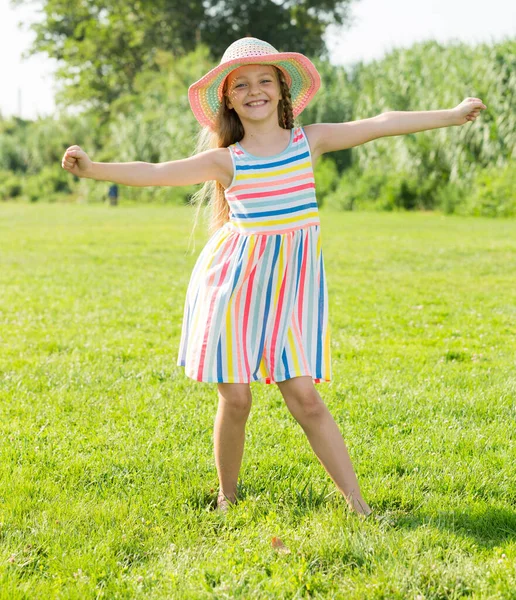 Girl in dress standing outdoors — Stock Photo, Image