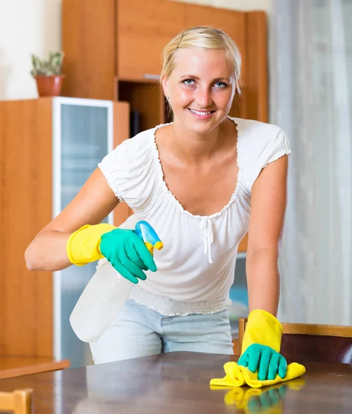 Blonde girl dusting in living room — Stock Photo, Image